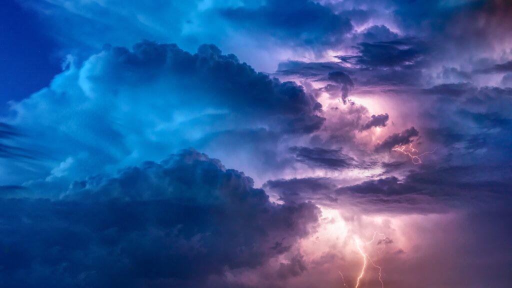 Colorful clouds with lightning bolt through them.